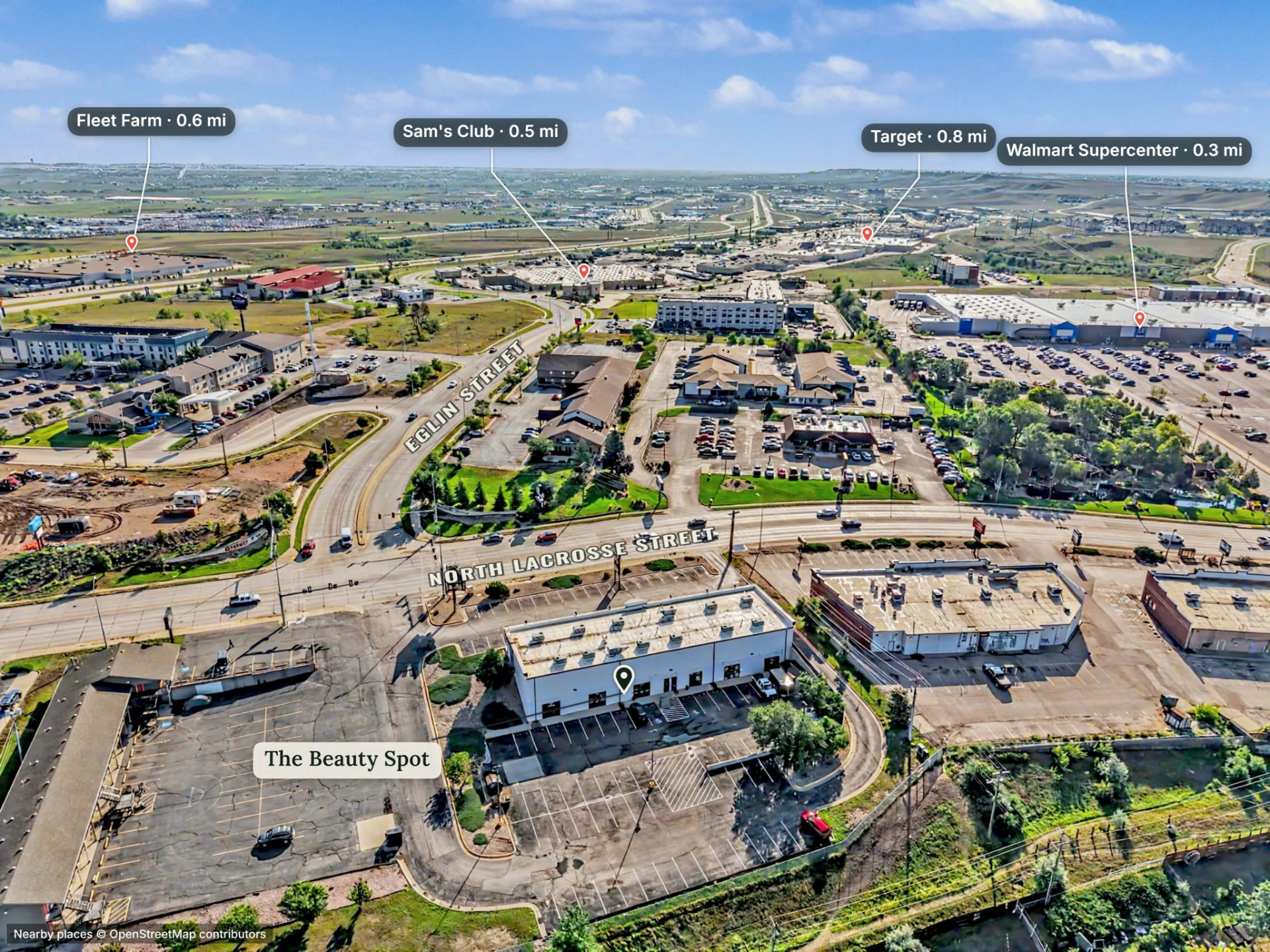 Aerial with automatic nearby-place pins in the designed pin style: school, park, trailhead, main street. — after
