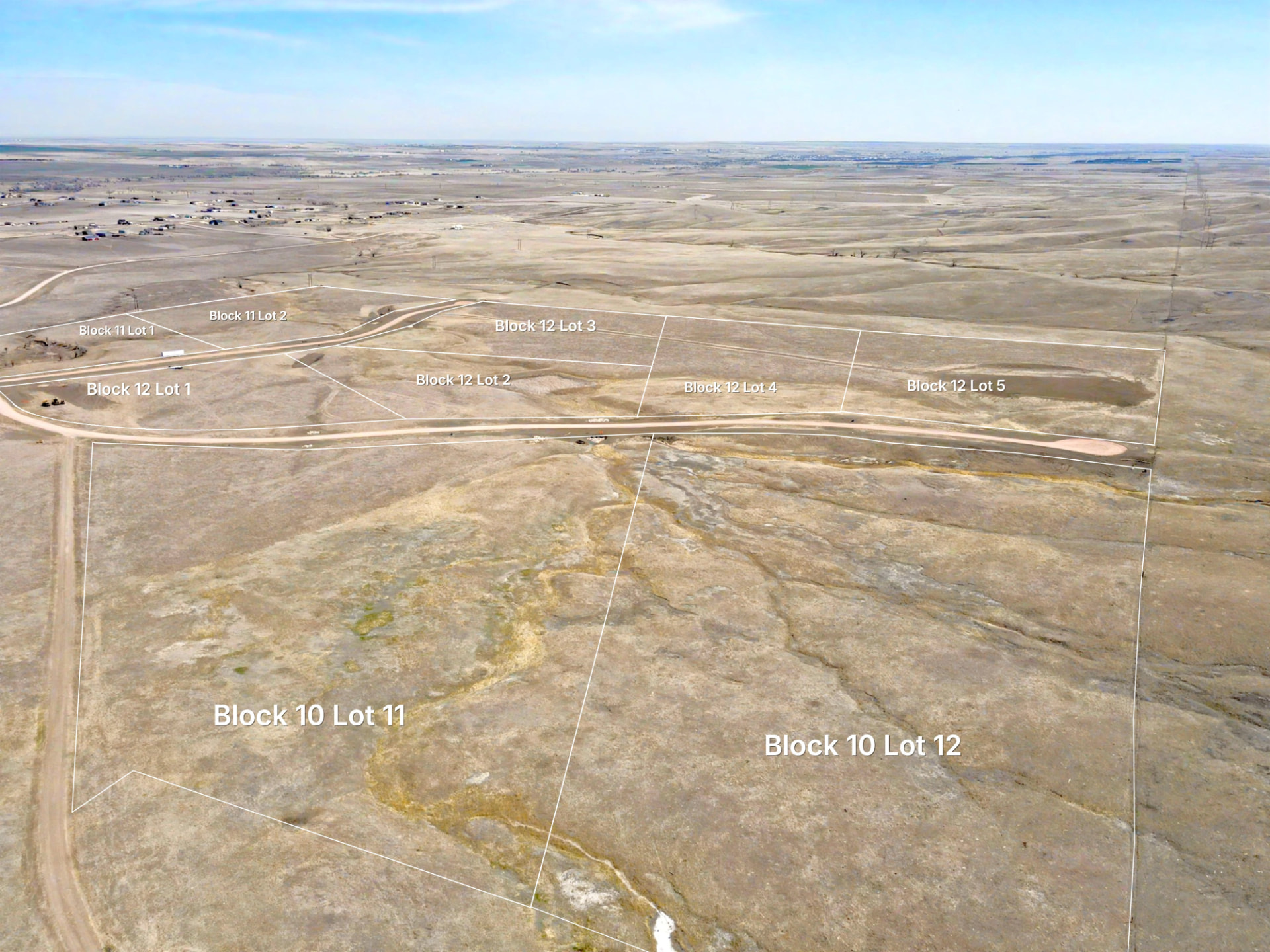 Wide aerial of a multi-lot subdivision with approximate parcel boundaries and lot numbers.